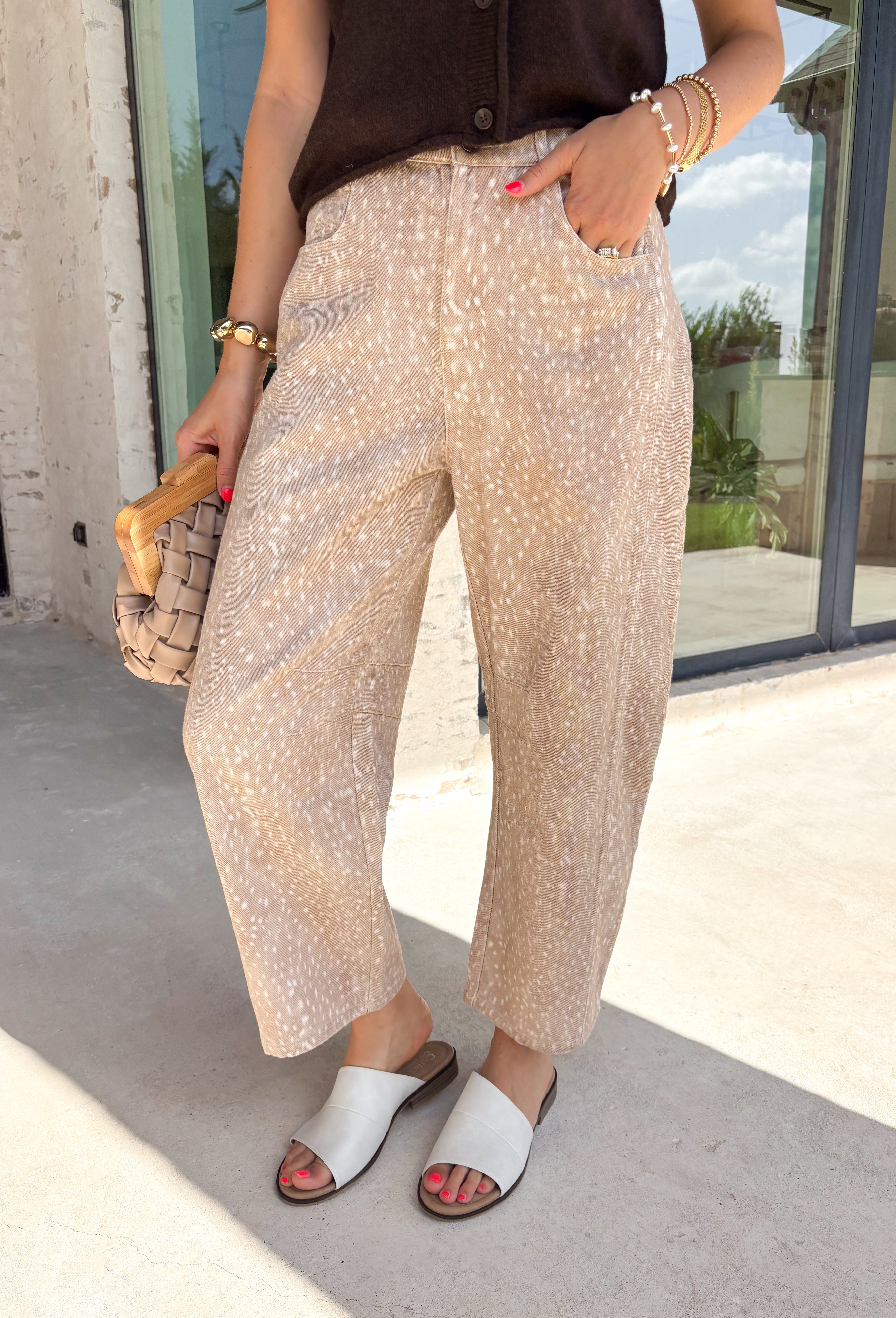 Bring a fresh twist to your fall wardrobe with these statement-making barrel jeans inspired by the beauty of the season! Designed in a warm tan hue with a subtle cream speckled fawn-inspired print, these jeans are the perfect blend of playful and polished. The on-trend barrel leg silhouette creates an effortlessly relaxed look while still feeling elevated enough for brunch dates, pumpkin patch adventures, and weekend shopping trips. 
