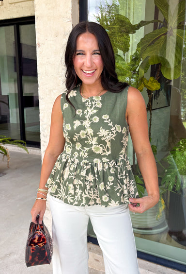 Feminine, flattering, and effortlessly versatile, this peplum top from Entro is a beautiful addition to your fall wardrobe. Designed in a rich olive hue with a soft cream floral print, this timeless top brings the perfect balance of classic style and seasonal charm. The round neckline creates a polished look, while the peplum silhouette offers a flattering, feminine shape.