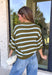 Fresh stripes and easy fall colors come together in this short sleeve sweater from Entro. The olive base is accented with off white and light blue stripes for a color combination that feels a little unexpected while still being easy to style. Made from 100% cotton, the knit has a comfortable feel that works especially well during those in-between fall days when it’s not quite cool enough for heavy layers. 