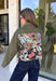 Make a statement everywhere you go with this stunning denim jacket from Veveret. Crafted in a rich olive denim, this standout layer features a breathtaking sheer embroidered floral design across the back, accented with shimmering sequins in shades of green, pink, orange, and brown. Coordinating floral sequin details on the front pockets tie the look together beautifully, while the classic collared neckline and button-front design keep it timeless. 