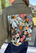 Make a statement everywhere you go with this stunning denim jacket from Veveret. Crafted in a rich olive denim, this standout layer features a breathtaking sheer embroidered floral design across the back, accented with shimmering sequins in shades of green, pink, orange, and brown. Coordinating floral sequin details on the front pockets tie the look together beautifully, while the classic collared neckline and button-front design keep it timeless. 
