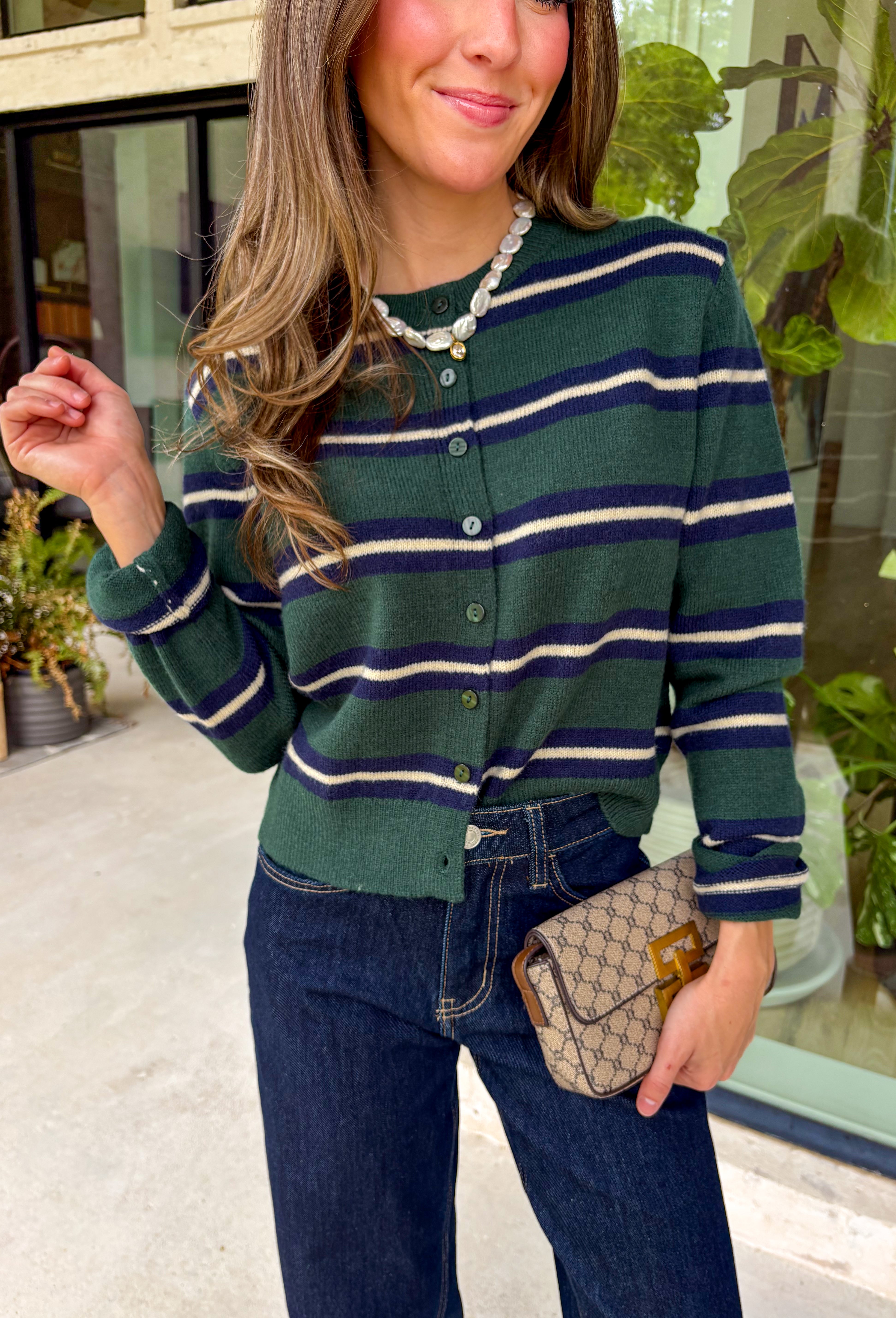 Nothing says cozy season quite like a classic striped cardigan! This hunter green knit features timeless navy blue and off white stripes, making it the perfect layering piece for all your fall adventures. Designed with a button-down front and an irresistibly soft feel, it's easy to wear open over your favorite basics or buttoned as a sweater for a polished look. 