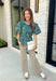 Add a little charm to your everyday wardrobe with this beautifully detailed blouse that's full of fall-inspired style. Featuring hunter green and light blue stripes layered with a neutral floral print, this top offers a fresh take on two timeless patterns. The puff sleeves, button-front design, and elastic drawstring waist create a flattering silhouette that's both comfortable and polished. 