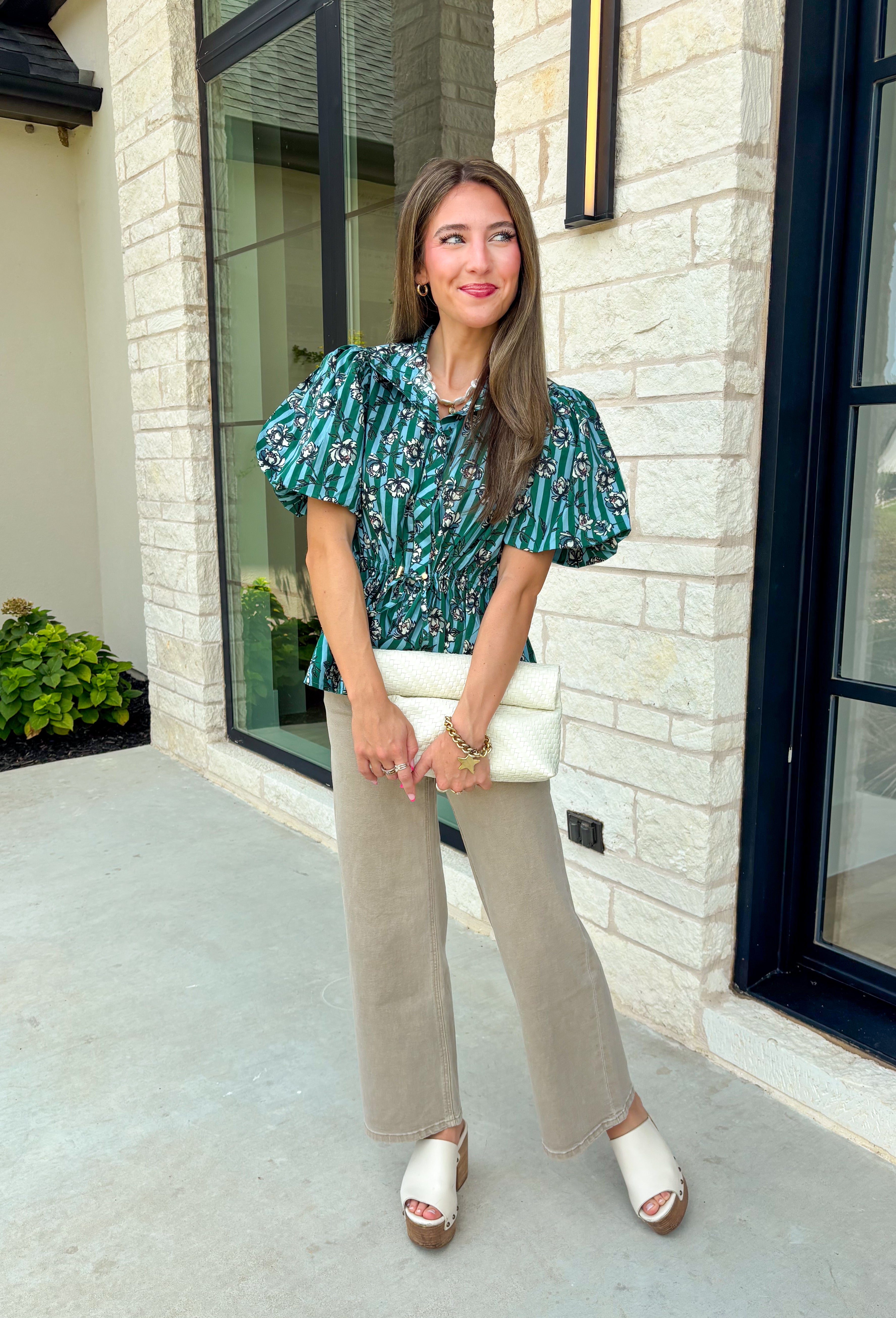 Add a little charm to your everyday wardrobe with this beautifully detailed blouse that's full of fall-inspired style. Featuring hunter green and light blue stripes layered with a neutral floral print, this top offers a fresh take on two timeless patterns. The puff sleeves, button-front design, and elastic drawstring waist create a flattering silhouette that's both comfortable and polished. 