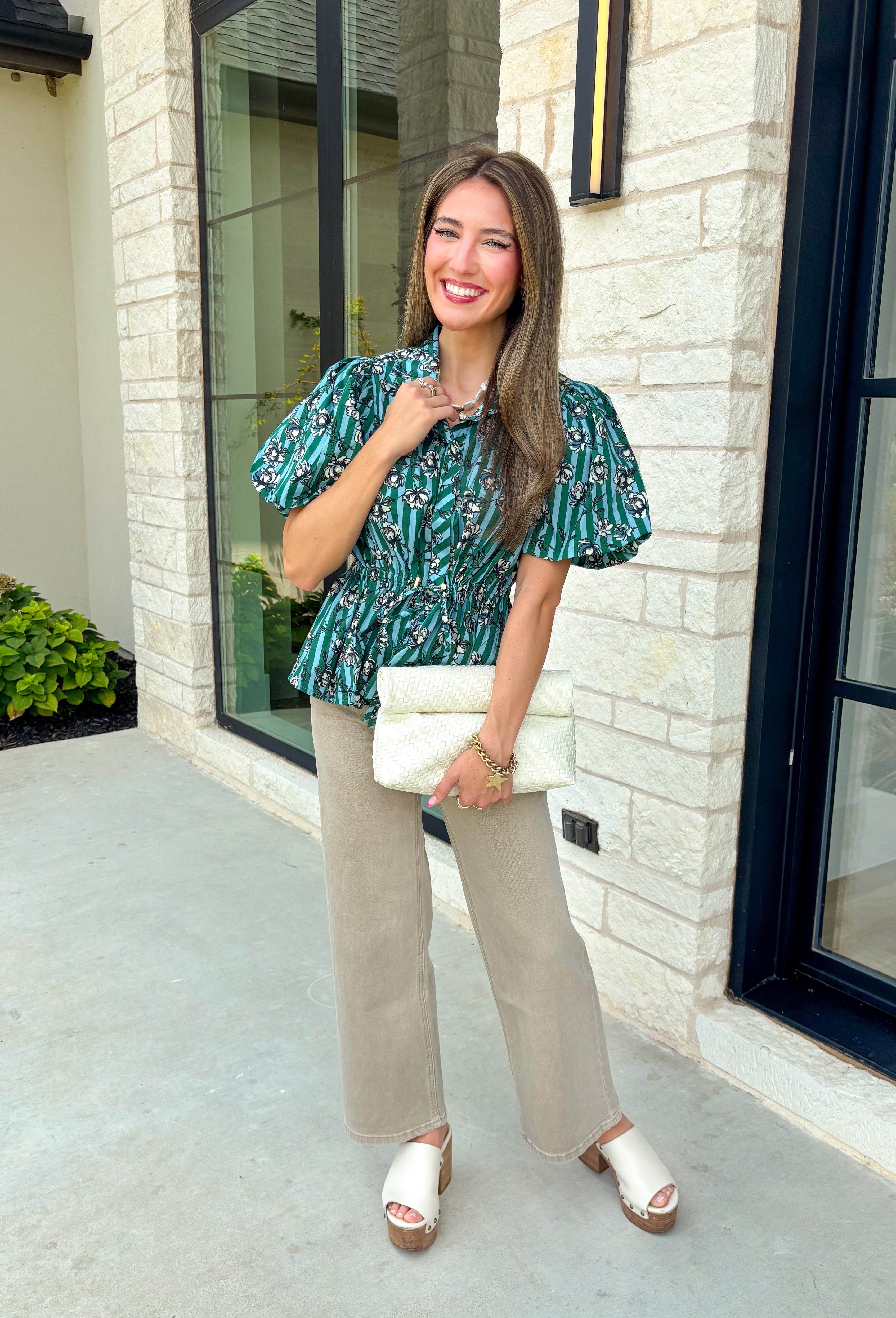 Add a little charm to your everyday wardrobe with this beautifully detailed blouse that's full of fall-inspired style. Featuring hunter green and light blue stripes layered with a neutral floral print, this top offers a fresh take on two timeless patterns. The puff sleeves, button-front design, and elastic drawstring waist create a flattering silhouette that's both comfortable and polished. 