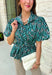 Add a little charm to your everyday wardrobe with this beautifully detailed blouse that's full of fall-inspired style. Featuring hunter green and light blue stripes layered with a neutral floral print, this top offers a fresh take on two timeless patterns. The puff sleeves, button-front design, and elastic drawstring waist create a flattering silhouette that's both comfortable and polished. 