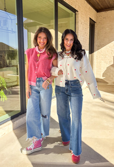 Bright, cheerful, and perfect for spring layering, this red and pink striped sleeveless button-down cardigan by Things Between is a fun statement piece. Designed in a sweater vest cardigan style, it features bold stripes and a rolled hem detail that gives it a relaxed, effortless feel. Lightweight with just the right amount of warmth, it’s ideal for layering over tees, tanks, or dresses as the seasons change.