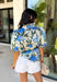 Fresh, feminine, and perfect for spring, this off-white button-down top by Entro is an easy standout. Featuring a blue floral print with pops of hunter green, it gives you the prettiest mix of color while still feeling classic and wearable. The ruffle neckline adds a sweet, polished touch, and puff sleeves bring that soft, feminine silhouette we love. Made from breathable cotton, this top is perfect for sunny days, brunch plans, and effortless spring outfits.