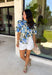 Fresh, feminine, and perfect for spring, this off-white button-down top by Entro is an easy standout. Featuring a blue floral print with pops of hunter green, it gives you the prettiest mix of color while still feeling classic and wearable. The ruffle neckline adds a sweet, polished touch, and puff sleeves bring that soft, feminine silhouette we love. Made from breathable cotton, this top is perfect for sunny days, brunch plans, and effortless spring outfits.