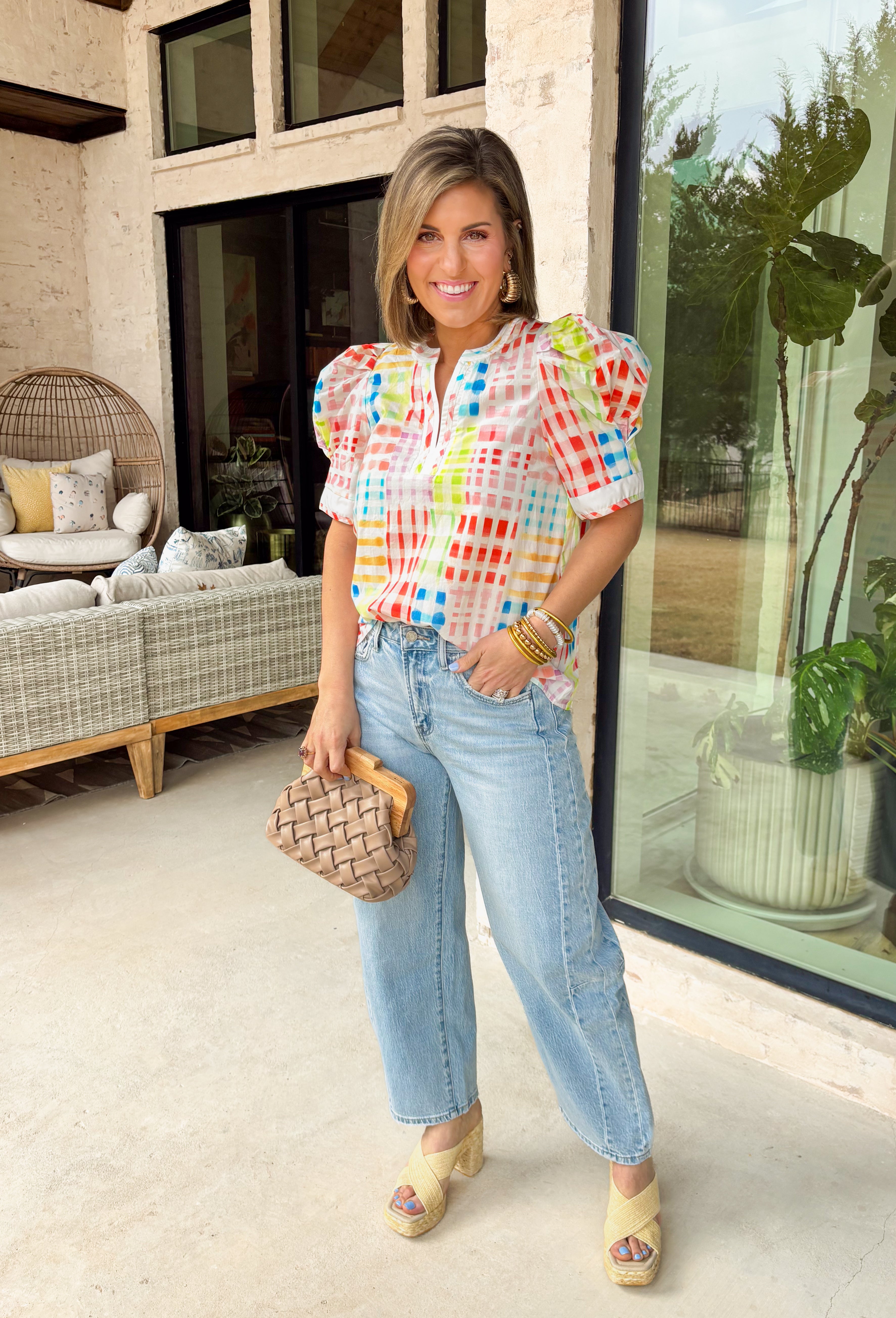 Bright, playful, and full of spring energy, this white short sleeve top by Entro is an instant mood booster. Featuring a colorful abstract gingham print in shades of green, blue, pink, red, yellow, and purple, it adds a fun twist to a classic pattern. Puff sleeves bring a soft, feminine touch, while the lightweight cotton fabric keeps it comfortable and breathable for sunny days.