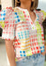 Bright, playful, and full of spring energy, this white short sleeve top by Entro is an instant mood booster. Featuring a colorful abstract gingham print in shades of green, blue, pink, red, yellow, and purple, it adds a fun twist to a classic pattern. Puff sleeves bring a soft, feminine touch, while the lightweight cotton fabric keeps it comfortable and breathable for sunny days.