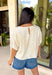 Understated and effortlessly pretty, this khaki short sleeve top is all about the details. The monochromatic floral embroidery adds soft texture without overwhelming the look, giving it that elevated, timeless feel you’ll reach for again and again. Designed with elastic cuff sleeves for a subtle puff effect and finished with a delicate keyhole closure in the back, this top blends feminine touches with everyday ease. The breathable linen blend keeps it lightweight and comfortable.
