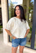 Understated and effortlessly pretty, this khaki short sleeve top is all about the details. The monochromatic floral embroidery adds soft texture without overwhelming the look, giving it that elevated, timeless feel you’ll reach for again and again. Designed with elastic cuff sleeves for a subtle puff effect and finished with a delicate keyhole closure in the back, this top blends feminine touches with everyday ease. The breathable linen blend keeps it lightweight and comfortable.