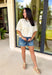 Understated and effortlessly pretty, this khaki short sleeve top is all about the details. The monochromatic floral embroidery adds soft texture without overwhelming the look, giving it that elevated, timeless feel you’ll reach for again and again. Designed with elastic cuff sleeves for a subtle puff effect and finished with a delicate keyhole closure in the back, this top blends feminine touches with everyday ease. The breathable linen blend keeps it lightweight and comfortable.