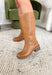A timeless staple for every season, these tan faux leather riding boots by Soda bring classic charm with a modern edge. Designed with a rounded square toe and a stacked 2" block heel, they’re the perfect blend of comfort and polish. Whether you’re pairing them with denim, dresses, or skirts, these boots are a go-to style that will carry you through every occasion in effortless fashion.