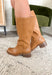 A timeless staple for every season, these tan faux leather riding boots by Soda bring classic charm with a modern edge. Designed with a rounded square toe and a stacked 2" block heel, they’re the perfect blend of comfort and polish. Whether you’re pairing them with denim, dresses, or skirts, these boots are a go-to style that will carry you through every occasion in effortless fashion.