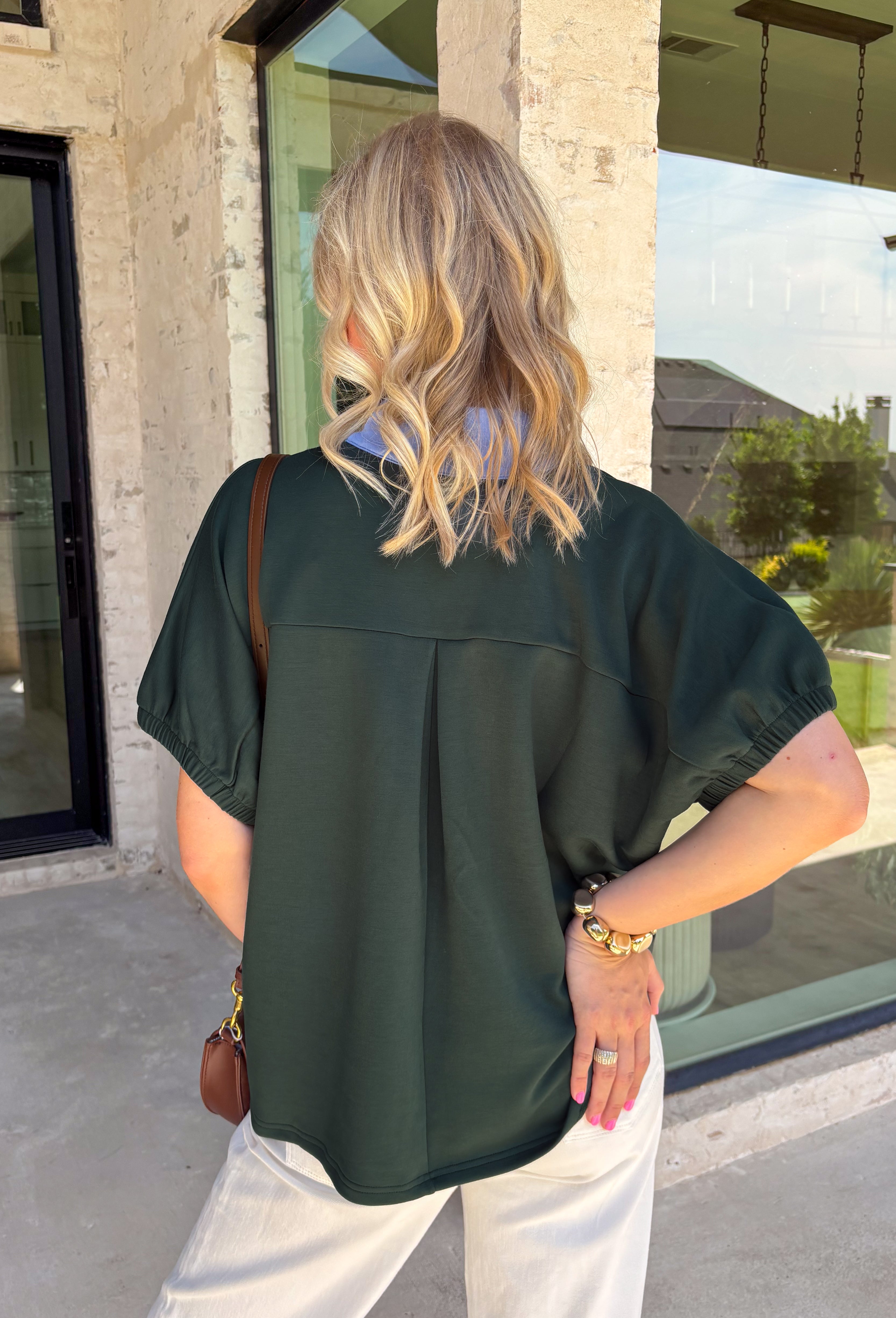 Bring a fresh pop of color to your fall wardrobe with this effortlessly polished forest green top! The rich seasonal hue is beautifully accented by light blue trim along the front, creating a timeless look with just the right amount of contrast. Soft elastic sleeves add a feminine touch while offering all-day comfort, and the stretchy knit fabric makes this an easy piece to wear from morning meetings to weekend outings. It's a versatile staple you'll reach for again and again throughout the season.