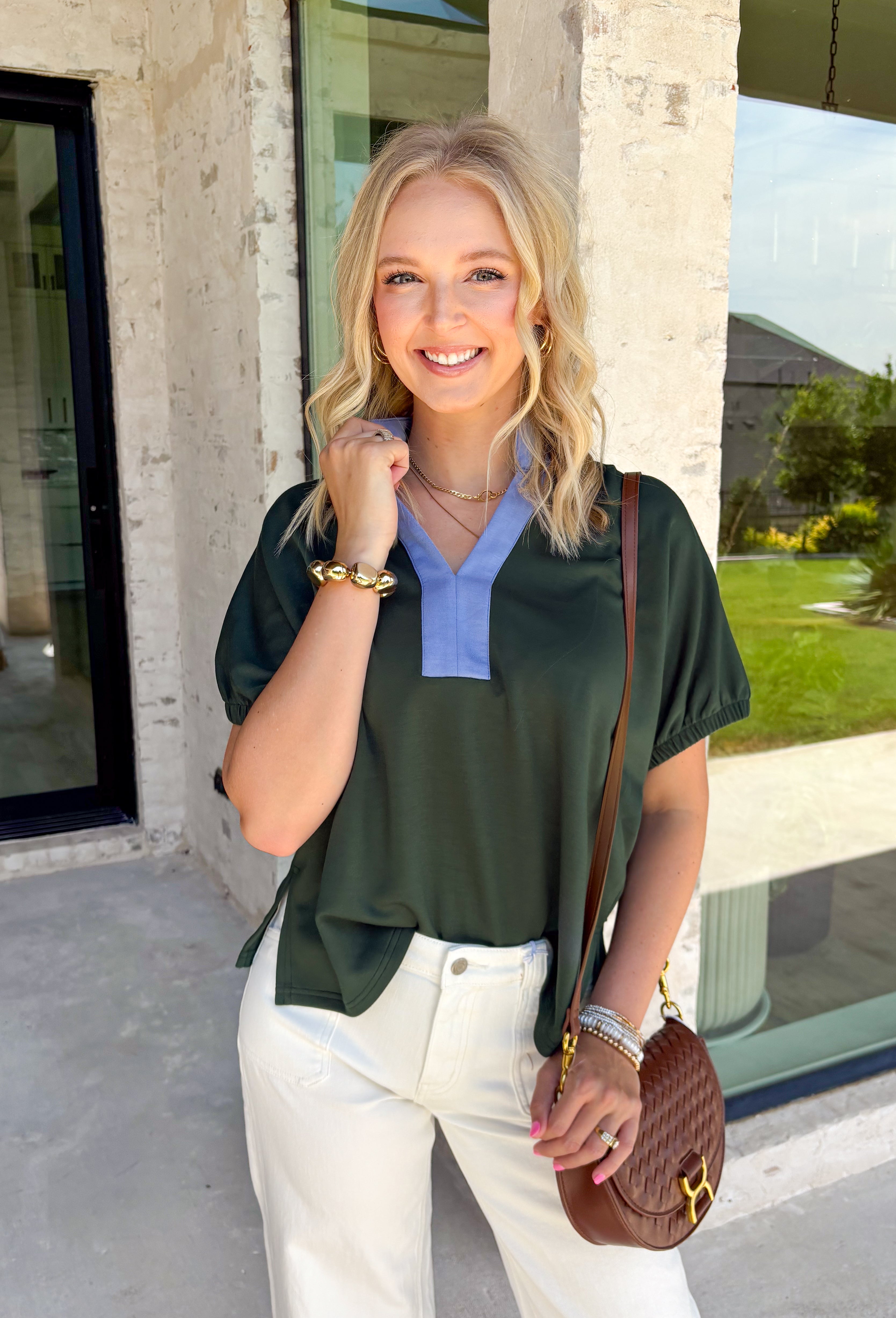 Bring a fresh pop of color to your fall wardrobe with this effortlessly polished forest green top! The rich seasonal hue is beautifully accented by light blue trim along the front, creating a timeless look with just the right amount of contrast. Soft elastic sleeves add a feminine touch while offering all-day comfort, and the stretchy knit fabric makes this an easy piece to wear from morning meetings to weekend outings. It's a versatile staple you'll reach for again and again throughout the season.
