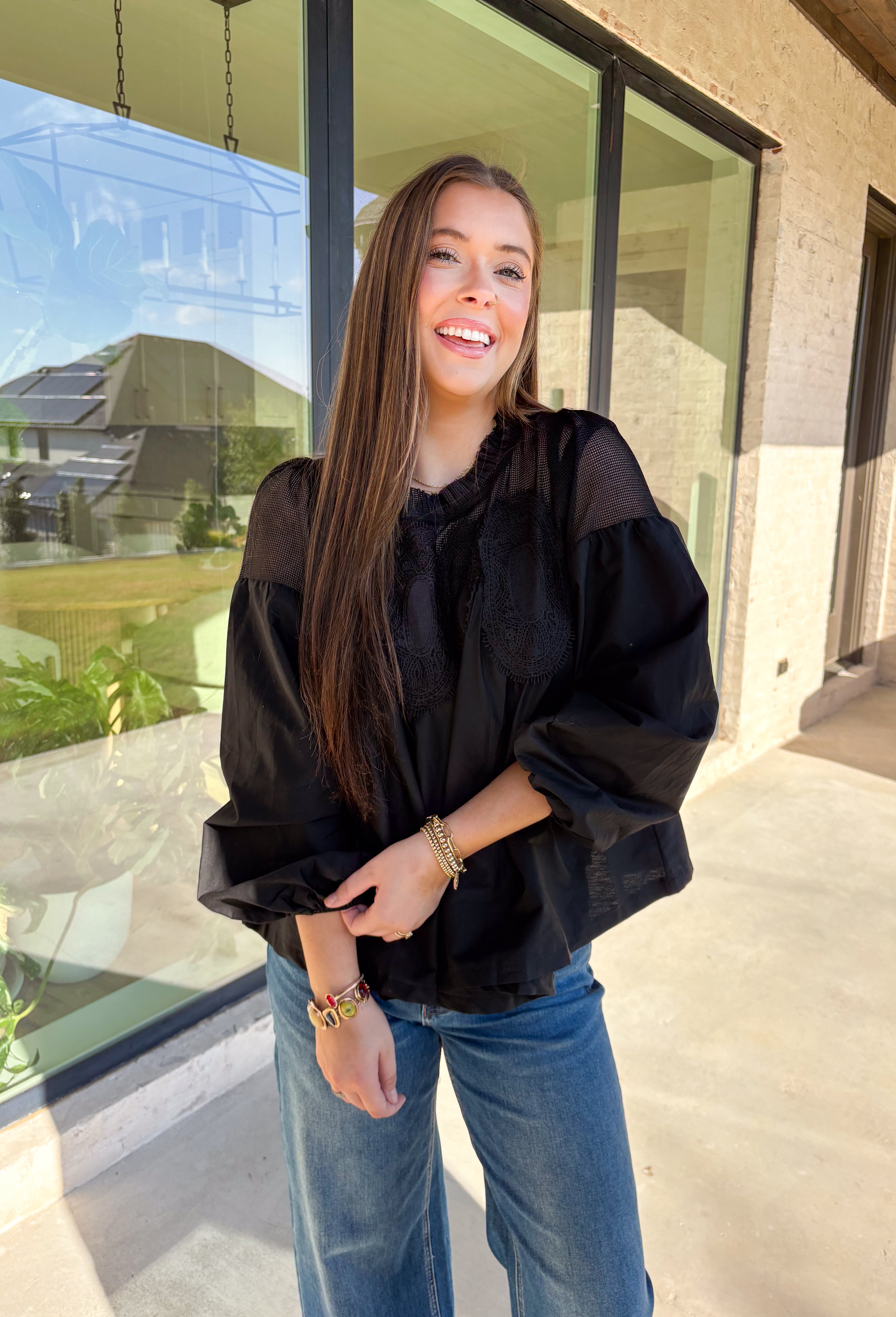 Timeless and elegant, this black long sleeve top by Fate brings a vintage-inspired touch to your winter wardrobe. Featuring balloon sleeves with elastic cuffs and intricate crochet lace detailing along the top, this piece feels effortlessly feminine. The sheer mesh overlay adds just the right hint of texture, making it a perfect choice for date nights, holiday dinners, or any winter occasion.