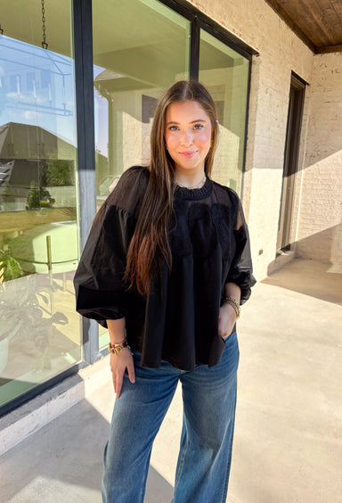 Timeless and elegant, this black long sleeve top by Fate brings a vintage-inspired touch to your winter wardrobe. Featuring balloon sleeves with elastic cuffs and intricate crochet lace detailing along the top, this piece feels effortlessly feminine. The sheer mesh overlay adds just the right hint of texture, making it a perfect choice for date nights, holiday dinners, or any winter occasion.