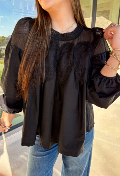 Timeless and elegant, this black long sleeve top by Fate brings a vintage-inspired touch to your winter wardrobe. Featuring balloon sleeves with elastic cuffs and intricate crochet lace detailing along the top, this piece feels effortlessly feminine. The sheer mesh overlay adds just the right hint of texture, making it a perfect choice for date nights, holiday dinners, or any winter occasion.
