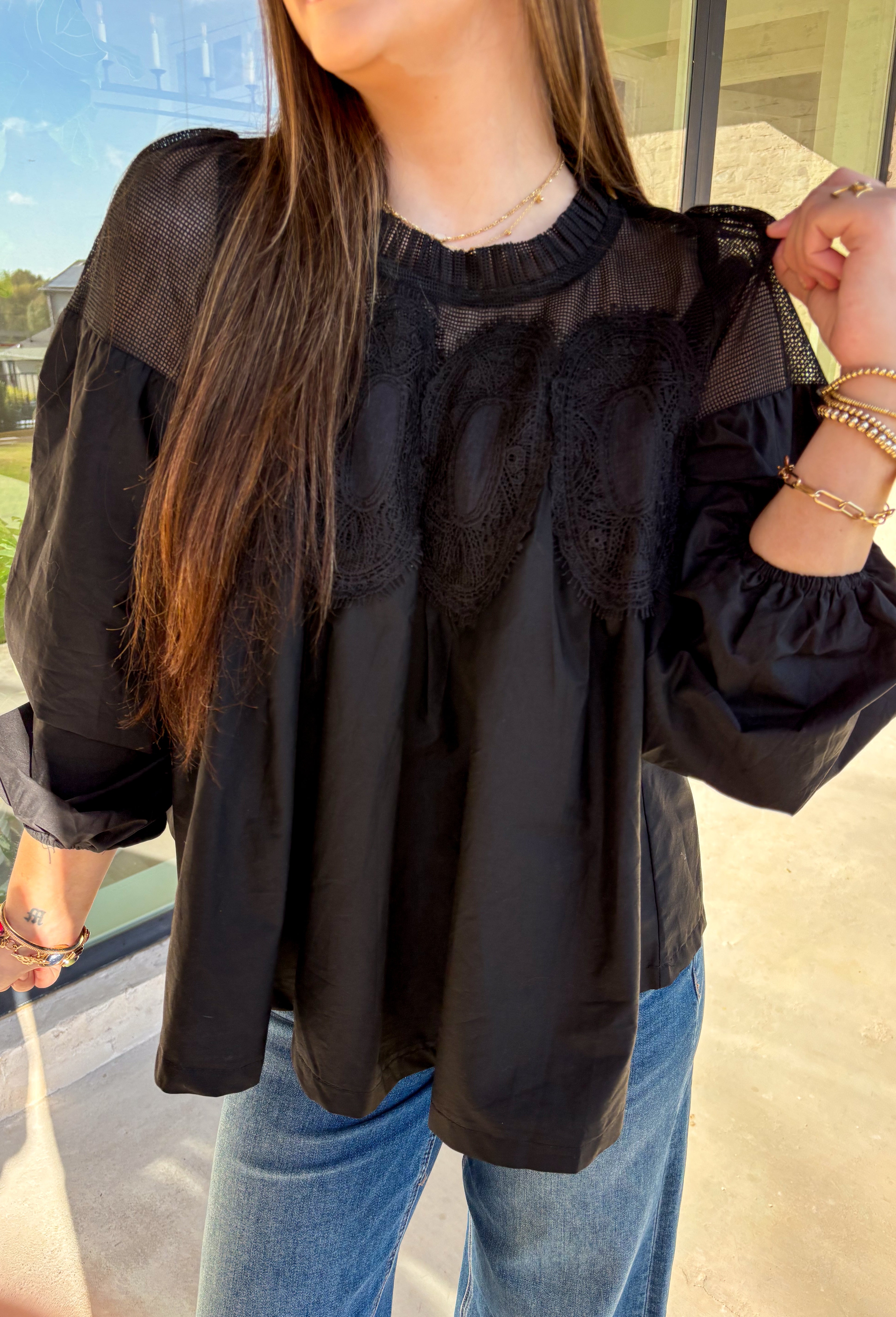 Timeless and elegant, this black long sleeve top by Fate brings a vintage-inspired touch to your winter wardrobe. Featuring balloon sleeves with elastic cuffs and intricate crochet lace detailing along the top, this piece feels effortlessly feminine. The sheer mesh overlay adds just the right hint of texture, making it a perfect choice for date nights, holiday dinners, or any winter occasion.