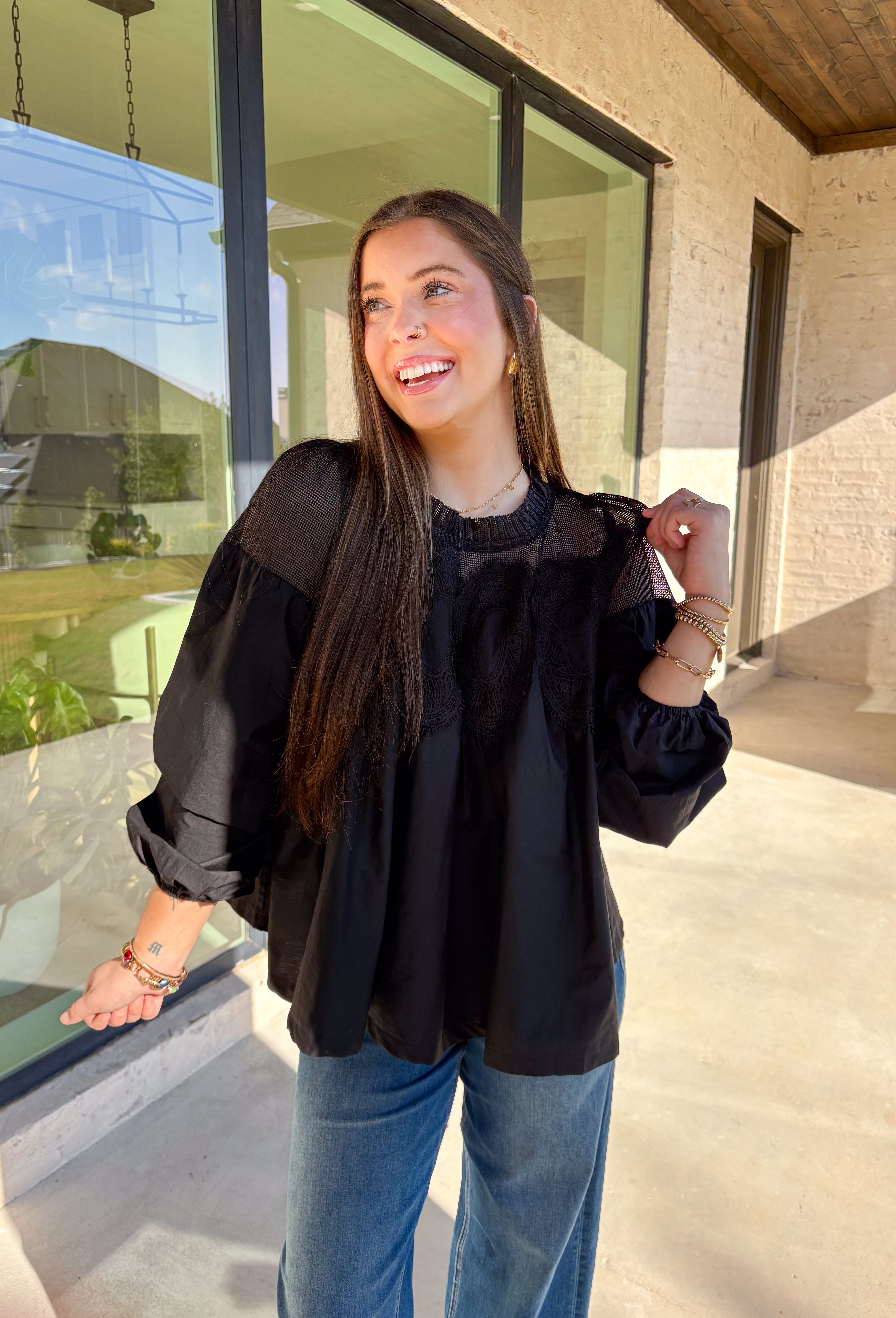 Timeless and elegant, this black long sleeve top by Fate brings a vintage-inspired touch to your winter wardrobe. Featuring balloon sleeves with elastic cuffs and intricate crochet lace detailing along the top, this piece feels effortlessly feminine. The sheer mesh overlay adds just the right hint of texture, making it a perfect choice for date nights, holiday dinners, or any winter occasion.