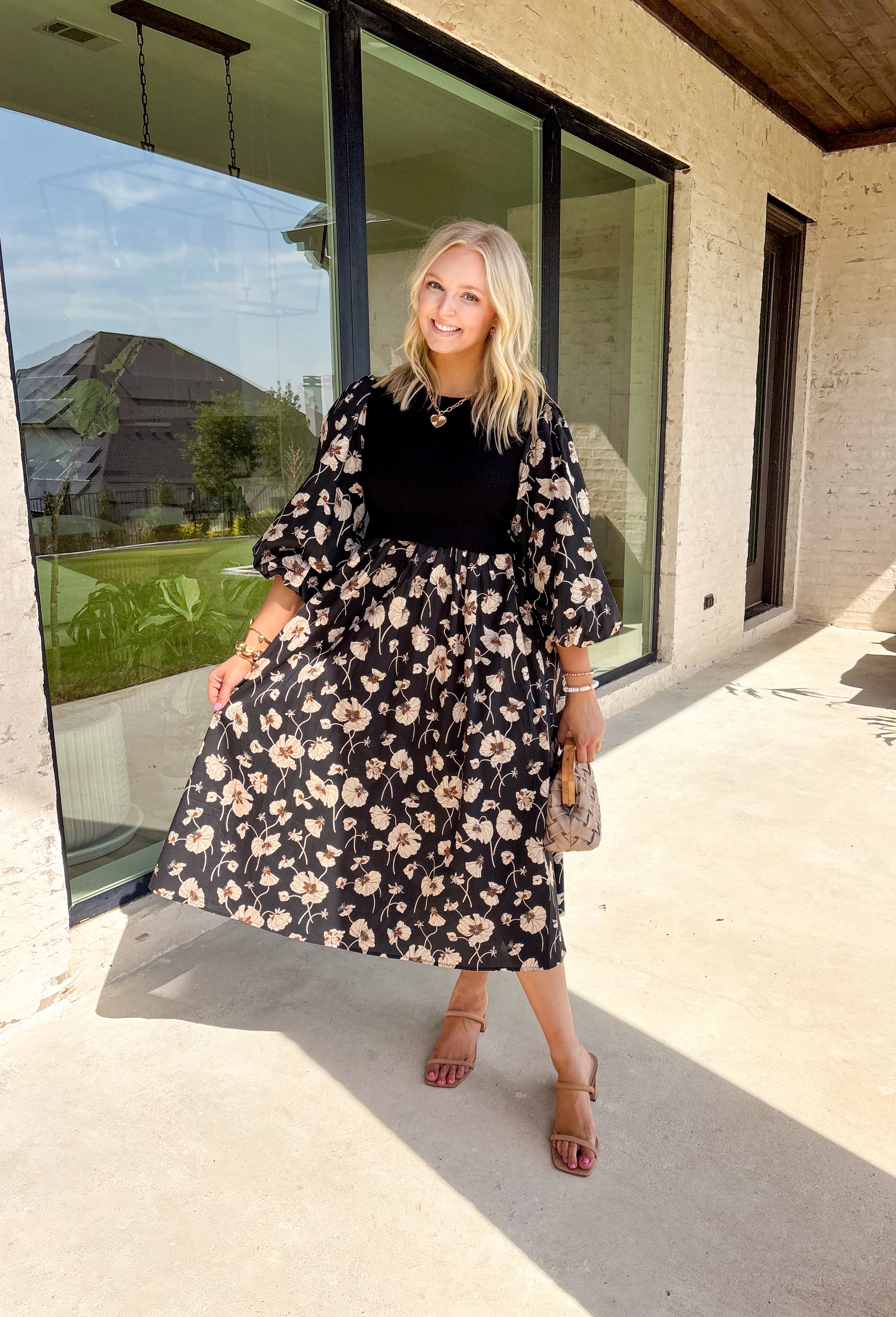 All the layered style, none of the layering fuss—this black midi dress makes autumn dressing a breeze. With a soft neutral floral print and solid black ribbed front panel, it creates that effortless "sweater over dress" vibe without adding bulk. The balloon sleeves and elastic cuffs give it a romantic, flowy feel, while the midi length keeps it versatile for boots or flats. Comfortable, polished, and totally ready for cooler days, this dress is the perfect blend of cozy and put-together.