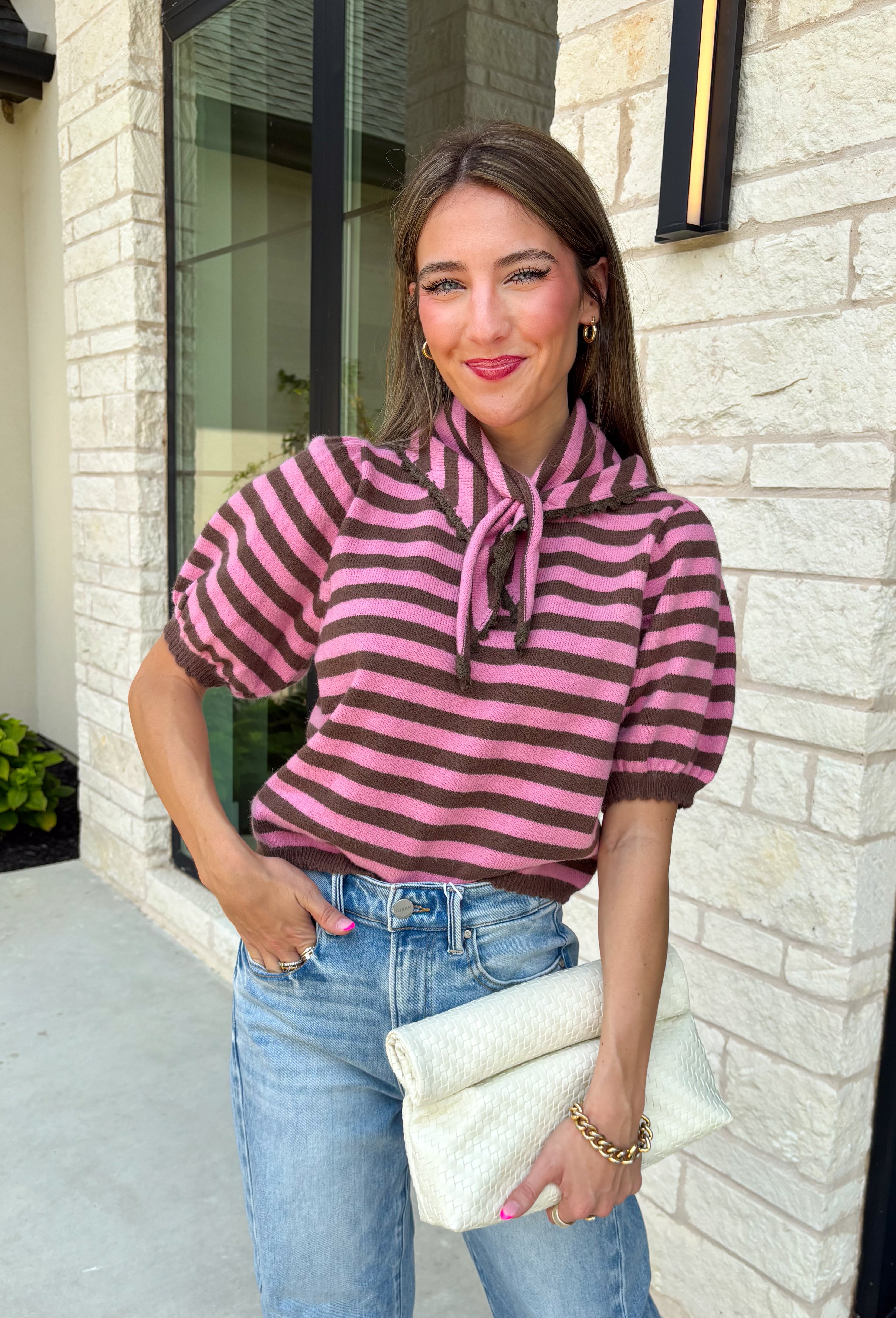 Sweet, polished, and full of charming details, this short sleeve sweater is the perfect way to elevate your fall wardrobe. Featuring pink and brown stripes, this cozy knit combines timeless color with feminine touches you'll love. The self-tie collar adds a playful finish, while the delicate scallop trim and puff sleeves create an effortlessly polished look. Whether you're headed to the office, brunch with friends, or a weekend coffee date, this sweater is an easy favorite you'll reach for all season long.