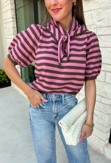 Sweet, polished, and full of charming details, this short sleeve sweater is the perfect way to elevate your fall wardrobe. Featuring pink and brown stripes, this cozy knit combines timeless color with feminine touches you'll love. The self-tie collar adds a playful finish, while the delicate scallop trim and puff sleeves create an effortlessly polished look. Whether you're headed to the office, brunch with friends, or a weekend coffee date, this sweater is an easy favorite you'll reach for all season long.