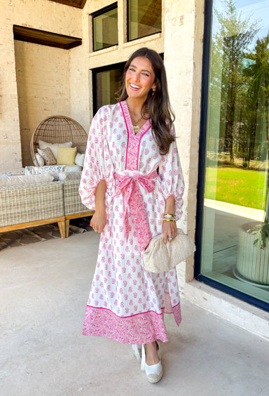 This white floral midi dress by Entro is giving the sweetest spring energy! Covered in a pretty pink floral print, it’s fresh, feminine, and perfect for everything from brunch dates to baby showers. The pink contrast trim adds such a fun pop and gives the dress that extra polished look, while the self-tie detail at the front waist lets you cinch it in for a flattering fit.