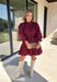 Rich burgundy makes this dress from Entro an easy favorite for all the plans filling up your fall calendar. The stand collar and split neckline create a classic look, while the button-front closure adds a pretty finishing detail. Long balloon sleeves bring soft volume to the silhouette and are finished with button cuffs for a more tailored touch. A removable self-tie belt lets you define the waist or switch up the look, while the tiered skirt adds movement and shape. 