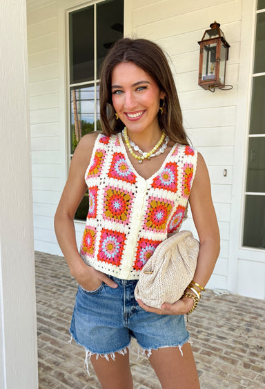 This sleeveless crochet lace embroidered top is bringing all the vibrant, sunshine-ready energy. Designed with a colorful mix of off white, orange, pink, blue, and mustard, it’s the kind of piece that instantly makes an outfit feel fun and fresh. The intricate crochet lace and embroidered details give it that handcrafted look we love, while the button-down front keeps it classic and easy to style. With its cropped length, it pairs perfectly with high-rise denim, skirts, or shorts.