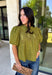 Pretty details make this olive top from Entro one you'll want to work into your fall rotation. The rich olive shade feels perfect for the season, while eyelet detailing and crochet trim add texture and interest to the solid design. A ruffled neckline brings a sweet finishing touch, and short puff sleeves give the silhouette just the right amount of shape. 