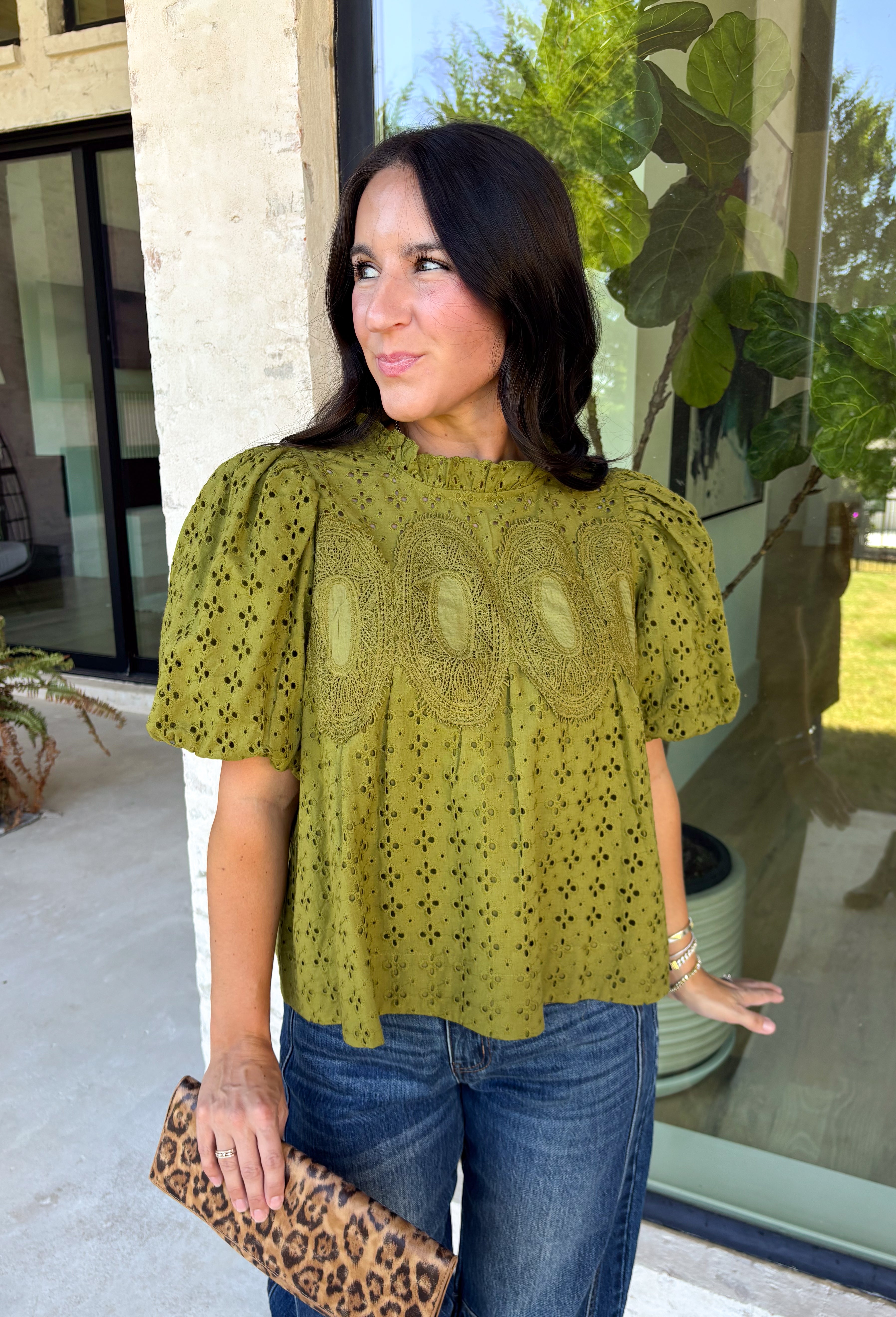 Pretty details make this olive top from Entro one you'll want to work into your fall rotation. The rich olive shade feels perfect for the season, while eyelet detailing and crochet trim add texture and interest to the solid design. A ruffled neckline brings a sweet finishing touch, and short puff sleeves give the silhouette just the right amount of shape. 