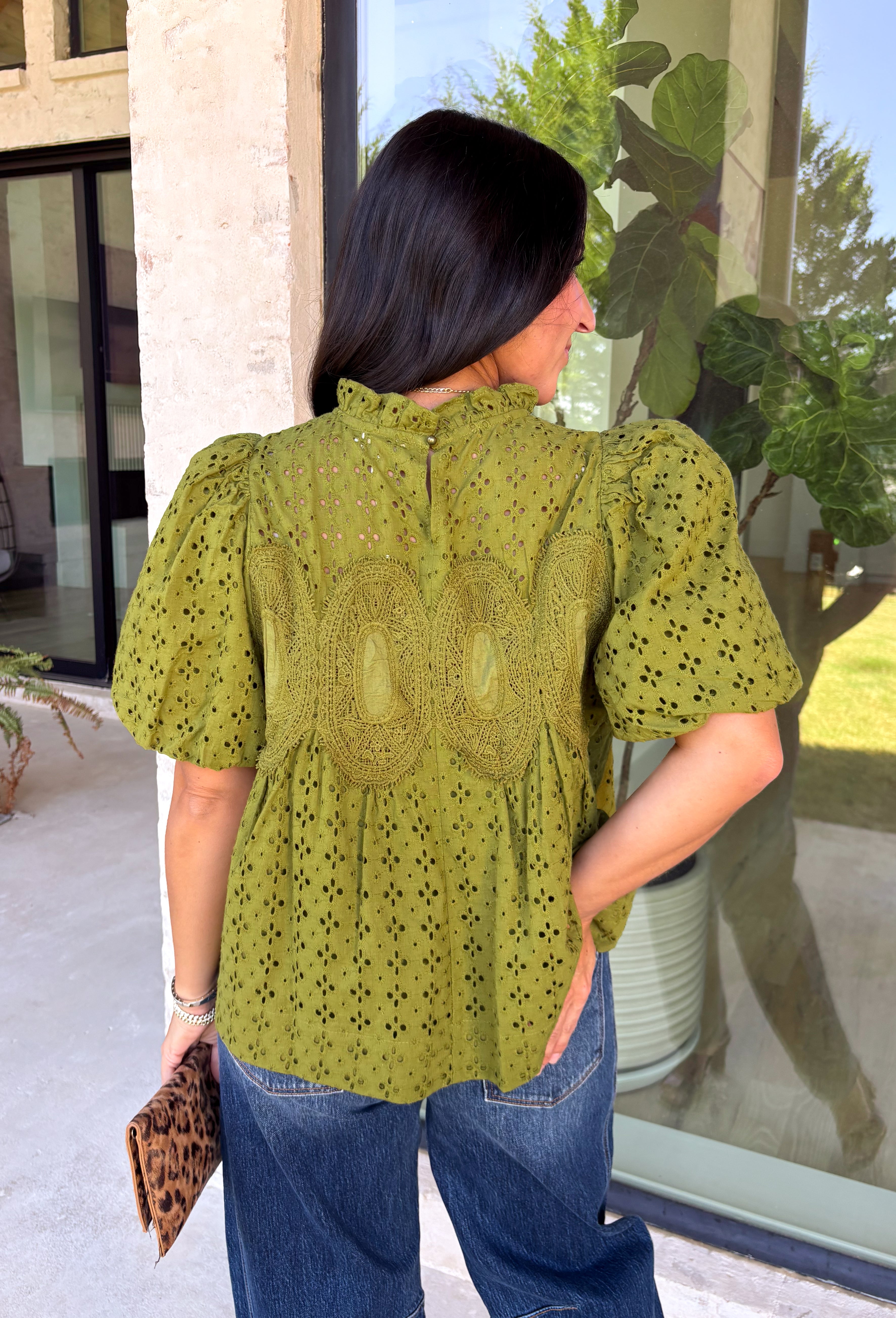 Pretty details make this olive top from Entro one you'll want to work into your fall rotation. The rich olive shade feels perfect for the season, while eyelet detailing and crochet trim add texture and interest to the solid design. A ruffled neckline brings a sweet finishing touch, and short puff sleeves give the silhouette just the right amount of shape. 