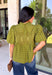 Pretty details make this olive top from Entro one you'll want to work into your fall rotation. The rich olive shade feels perfect for the season, while eyelet detailing and crochet trim add texture and interest to the solid design. A ruffled neckline brings a sweet finishing touch, and short puff sleeves give the silhouette just the right amount of shape. 