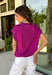 Add a beautiful pop of color to your fall wardrobe with this soft orchid knit top. The rich orchid hue brings a fresh twist to classic autumn styling, making it easy to pair with your favorite dark wash denim, cream trousers, or printed skirts. Designed with a timeless round neckline and flattering cap sleeves, this lightweight knit is perfect for layering under jackets and cardigans as the weather cools. 