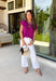 Add a beautiful pop of color to your fall wardrobe with this soft orchid knit top. The rich orchid hue brings a fresh twist to classic autumn styling, making it easy to pair with your favorite dark wash denim, cream trousers, or printed skirts. Designed with a timeless round neckline and flattering cap sleeves, this lightweight knit is perfect for layering under jackets and cardigans as the weather cools. 