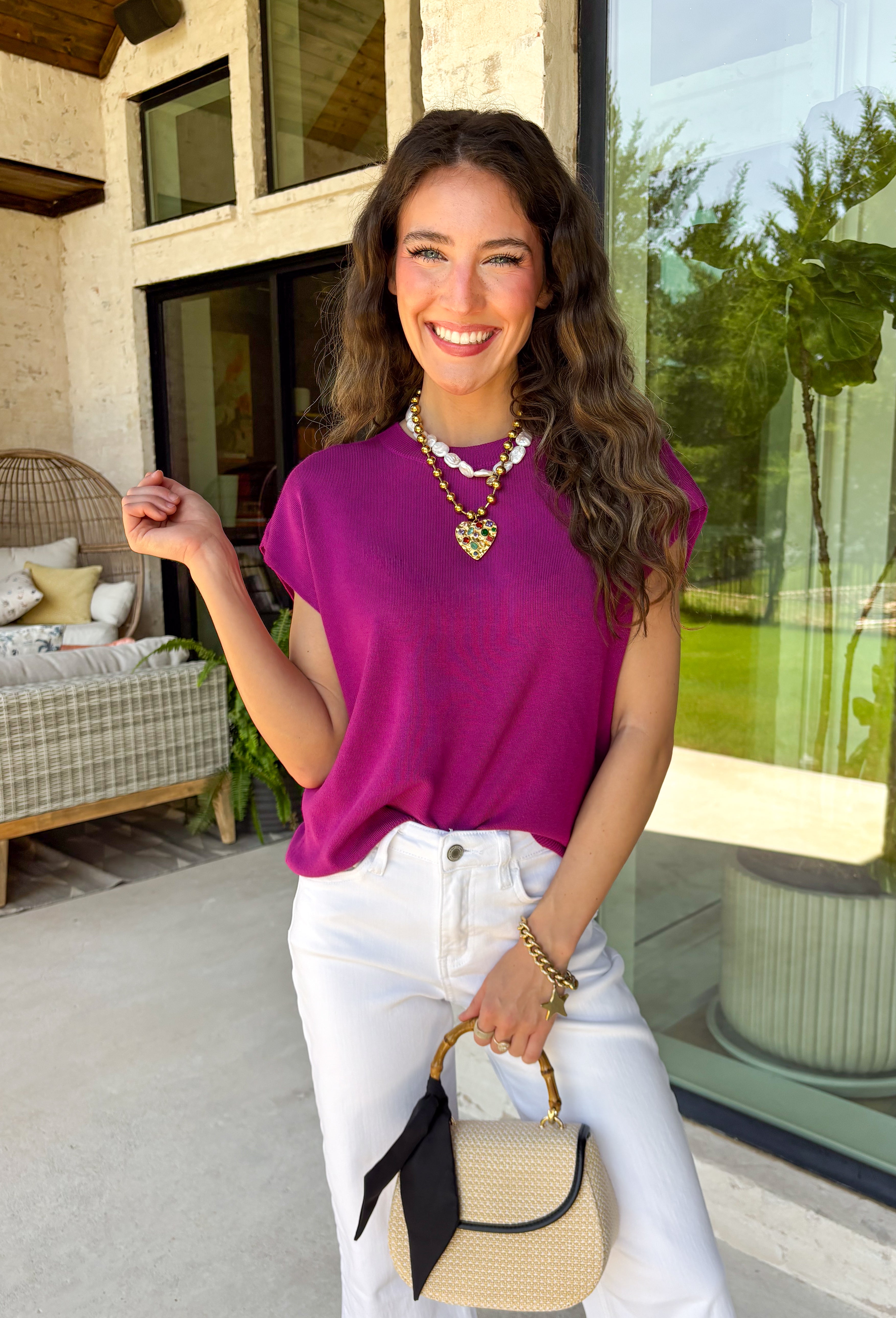 Add a beautiful pop of color to your fall wardrobe with this soft orchid knit top. The rich orchid hue brings a fresh twist to classic autumn styling, making it easy to pair with your favorite dark wash denim, cream trousers, or printed skirts. Designed with a timeless round neckline and flattering cap sleeves, this lightweight knit is perfect for layering under jackets and cardigans as the weather cools. 