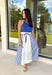 Sporty meets polished in this sleeveless midi dress by Entro—an effortless spring staple you’ll love wearing on repeat. The royal blue top features crisp white trim along the neckline and arm openings, while the white skirt is accented with royal blue and white stripe detailing along the sides for a clean, flattering look. An elastic tie waist adds comfort and shape, and side pockets make it as practical as it is cute. Fully lined and made from breathable cotton, this dress is perfect for all season long.