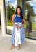 Sporty meets polished in this sleeveless midi dress by Entro—an effortless spring staple you’ll love wearing on repeat. The royal blue top features crisp white trim along the neckline and arm openings, while the white skirt is accented with royal blue and white stripe detailing along the sides for a clean, flattering look. An elastic tie waist adds comfort and shape, and side pockets make it as practical as it is cute. Fully lined and made from breathable cotton, this dress is perfect for all season long.
