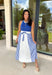 Sporty meets polished in this sleeveless midi dress by Entro—an effortless spring staple you’ll love wearing on repeat. The royal blue top features crisp white trim along the neckline and arm openings, while the white skirt is accented with royal blue and white stripe detailing along the sides for a clean, flattering look. An elastic tie waist adds comfort and shape, and side pockets make it as practical as it is cute. Fully lined and made from breathable cotton, this dress is perfect for all season long.