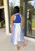 Sporty meets polished in this sleeveless midi dress by Entro—an effortless spring staple you’ll love wearing on repeat. The royal blue top features crisp white trim along the neckline and arm openings, while the white skirt is accented with royal blue and white stripe detailing along the sides for a clean, flattering look. An elastic tie waist adds comfort and shape, and side pockets make it as practical as it is cute. Fully lined and made from breathable cotton, this dress is perfect for all season long.