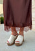 Bring a touch of romance to your fall wardrobe with this stunning chocolate brown satin midi skirt. Crafted from silky satin that catches the light beautifully, this chic skirt is finished with a delicate lace hem for an effortlessly feminine look. The elastic waistband offers all-day comfort while the side zipper creates a flattering, polished fit. Whether you're styling it for holiday gatherings, date nights, or elevating your everyday look, this timeless piece is one you'll love season after season.
