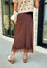 Bring a touch of romance to your fall wardrobe with this stunning chocolate brown satin midi skirt. Crafted from silky satin that catches the light beautifully, this chic skirt is finished with a delicate lace hem for an effortlessly feminine look. The elastic waistband offers all-day comfort while the side zipper creates a flattering, polished fit. Whether you're styling it for holiday gatherings, date nights, or elevating your everyday look, this timeless piece is one you'll love season after season.