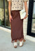 Bring a touch of romance to your fall wardrobe with this stunning chocolate brown satin midi skirt. Crafted from silky satin that catches the light beautifully, this chic skirt is finished with a delicate lace hem for an effortlessly feminine look. The elastic waistband offers all-day comfort while the side zipper creates a flattering, polished fit. Whether you're styling it for holiday gatherings, date nights, or elevating your everyday look, this timeless piece is one you'll love season after season.