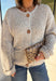 Wrap yourself in all the cozy fall vibes with this chunky knit cardigan! The neutral knit is beautifully accented with subtle orange and black speckles, giving it the perfect autumn-inspired look that's easy to style with everything in your closet. Finished with charming wooden buttons and functional front pockets, this cardigan is made for crisp mornings, pumpkin patch outings, coffee runs, and relaxing weekends. 