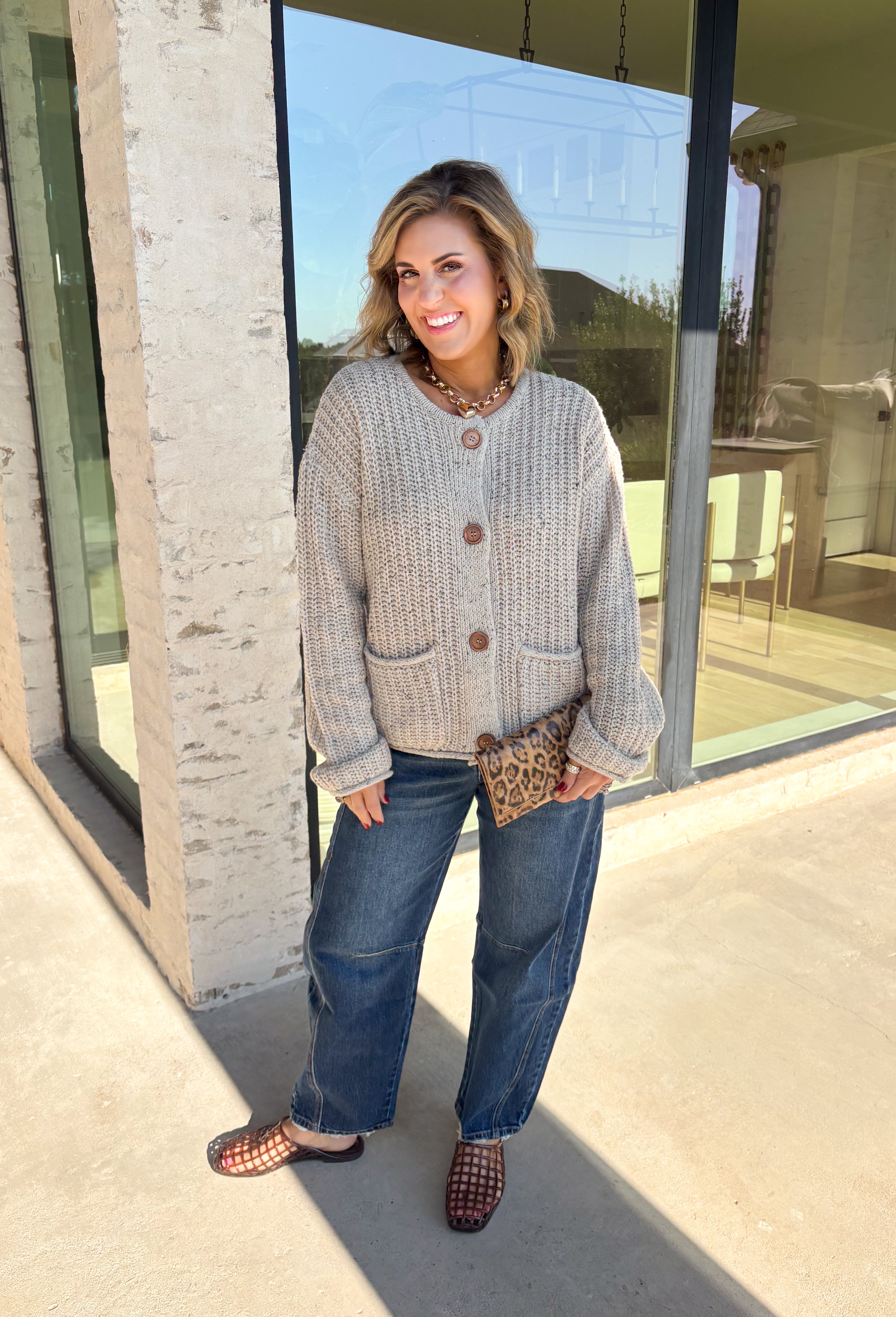 Wrap yourself in all the cozy fall vibes with this chunky knit cardigan! The neutral knit is beautifully accented with subtle orange and black speckles, giving it the perfect autumn-inspired look that's easy to style with everything in your closet. Finished with charming wooden buttons and functional front pockets, this cardigan is made for crisp mornings, pumpkin patch outings, coffee runs, and relaxing weekends. 