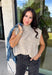 Easy to layer and perfect for those in-between weather days, this oatmeal sleeveless sweater from Day + Moon brings a cozy feel without the extra weight. The soft neutral shade makes it endlessly versatile, while open knit detailing along the front adds texture and gives the simple silhouette a little something extra. A mock neckline adds a classic cold-weather touch, making it especially cute layered under a jacket or cardigan as temperatures start to drop. 